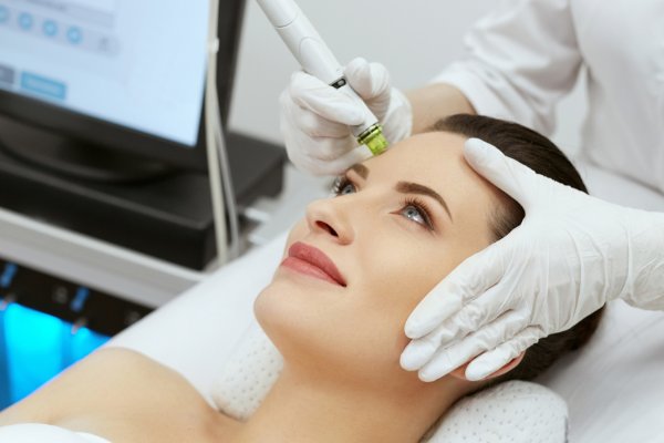Erika Tutoni receiving a facial treatment at a beauty salon.